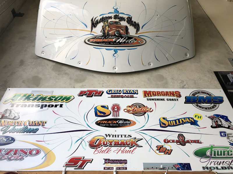 A pinstriped panel above a board of painted company logos