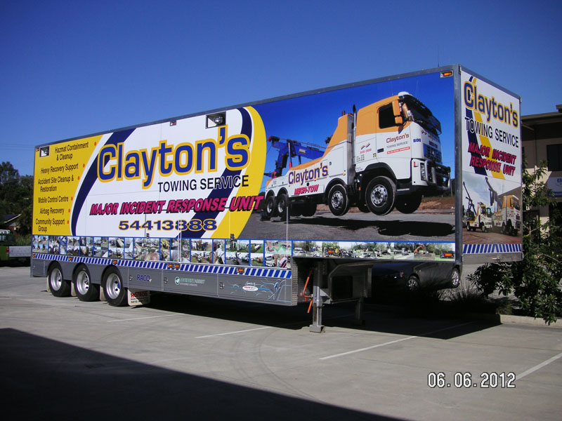 Clayton's Towing Service trailer covered in a full printed graphic